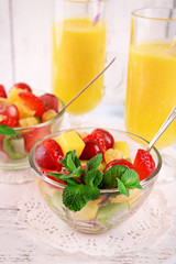 Fruit salad with mint and orange juice in glassware