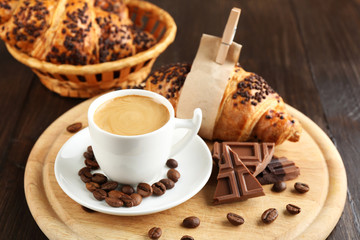 Fresh and tasty croissants with chocolate and cup of coffee