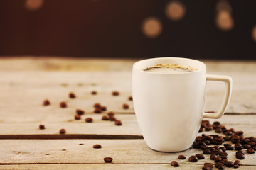 Cup of coffee on table on brown background