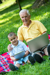 grandfather and child using laptop