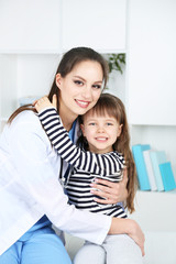 Little girl and young doctor in hospital