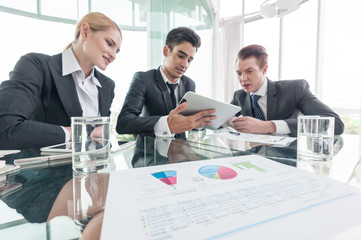 business partners discussing documents and ideas at meeting