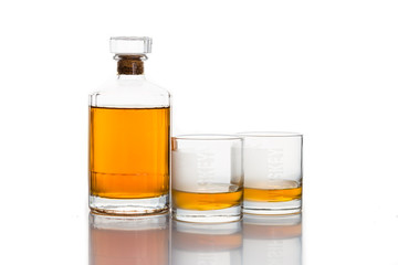 Two whiskey on neat, with a whiskey bottle
