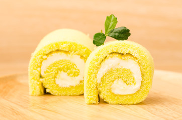 Roll cake on wooden plate