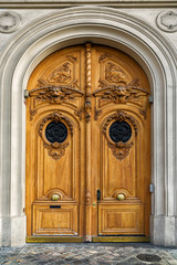 Beautiful old wooden door in Paris, France. Lion heads and other