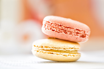 Close up of two macaroon cookies in pastel colors. Selective foc