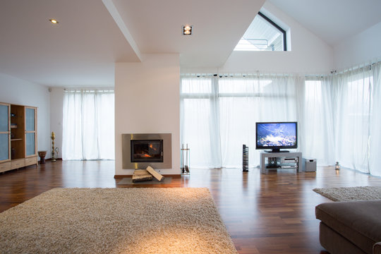 Cozy living room with large windows and fireplace