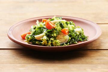 Salad with quail egg and basil in plate