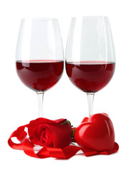 Composition with red wine in glasses, red rose, ribbon and