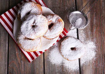 Delicious donuts with icing and powdered sugar