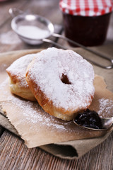 Delicious donuts with icing and powdered sugar