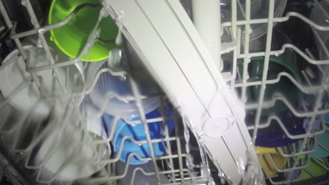 Interior view dishwasher cleaning a full load of dishware