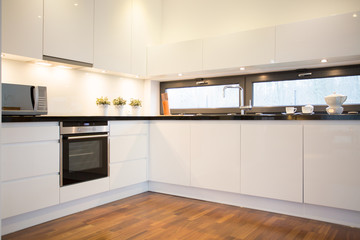 White kitchen with wooden floor