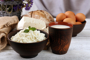 Tasty dairy products with bread and dry flowers