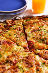 Tasty pizza with tableware on wooden table close up