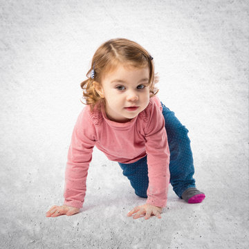 Little girl crawling over white background