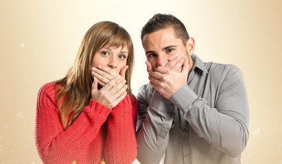 Couple surprised over white background