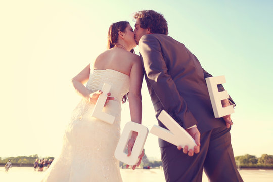 Bride and groom holding love letters in their hands
