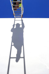 Thai man climbing on ladder for work