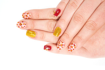 Beautiful multi-colored nail polish on fingers.