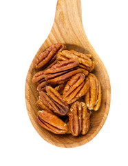 pecan nuts in a wooden spoon
