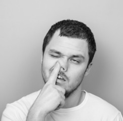 Portrait of a young man with his finger in his nose - Monocrome