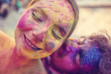Bride and groom in the city playing with holi powder