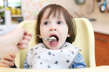 2 years boy feeding wheat porridge