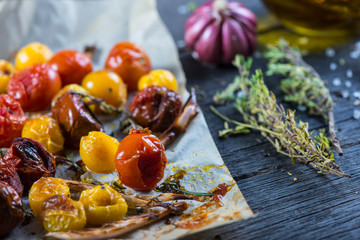 Freshly roasted vegetables with herbs on wooden table