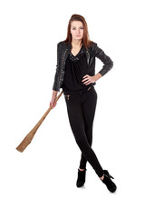 Fototapeta premium Young girl in black leather jacket holding wooden club isolated
