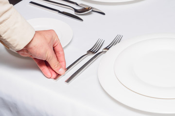 Waiter holding fork