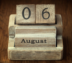 A very old wooden vintage calendar showing the date 6th August o