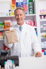 Senior pharmacist showing a envelope