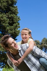 Father and daughter having fun in the park