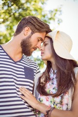 Hipster couple smiling at each other