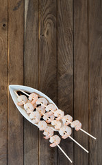 Three skewers with shrimps