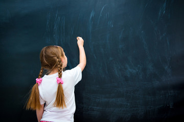 little girl against blackboard