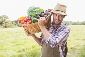 Farmer carrying basket of veg