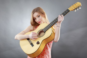 Obraz premium a beautiful young blonde with a classical guitar