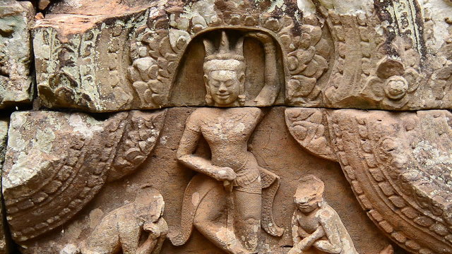 Zoom out-  Stone Carving of Buddha Goddess on Temple Wall - Angkor Wat, Cambodia