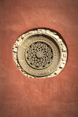 Red wall and stone friezes Zica Monastery