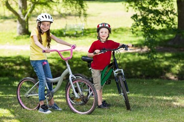 Happy siblings on their bike