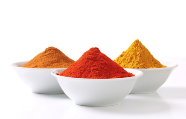 Curry powder, paprika and ground cinnamon - obrazy, fototapety, plakaty