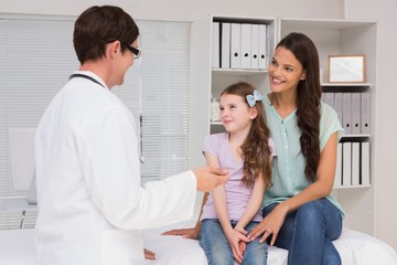 Fototapeta premium Doctor examining little girl with her mother