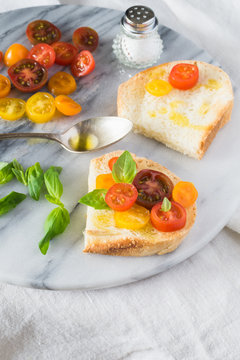 Bruschetta with a Mix of Red, Orange and Yellow Cherry Tomatoes