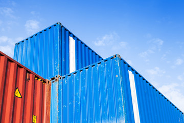 Blue and red metal Industrial cargo containers are stacked
