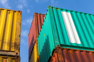 Colorful metal cargo containers under blue cloudy sky
