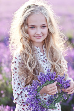 Beautiful smal blond girl on the lavender field