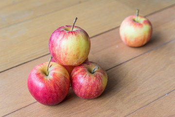 fresh red apples on wooden surface