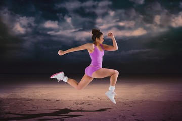 Composite image of fit brunette running and jumping